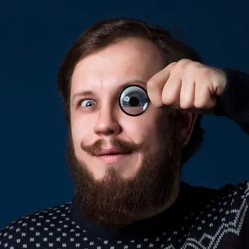 Valerii Karpov, the engineer behind VKVstudio, holding a lens to his eye